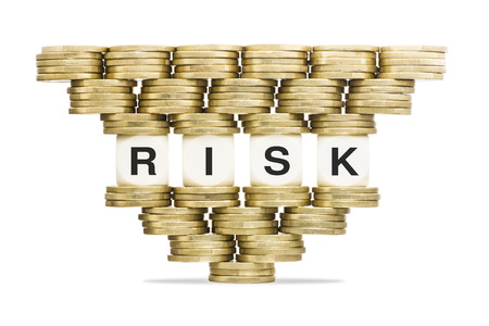 Risk Management Word RISK on Unstable Stack of Gold Coinsの写真素材