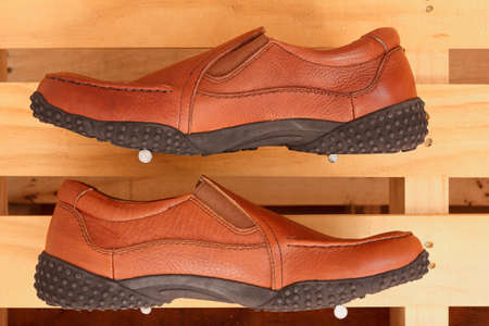 men brown genuine leather shoes on wood background
