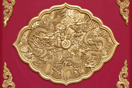 golden dragons on red wood backgroundの写真素材