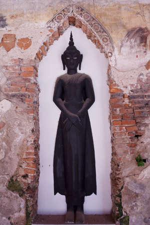 standing black buddha in the old archの写真素材