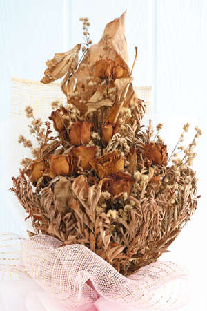 bouquet of dried withered roses on blue backgroundの写真素材