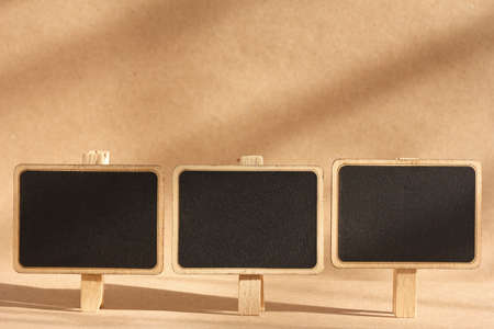 blank standing blackboard on brown backgroundの写真素材