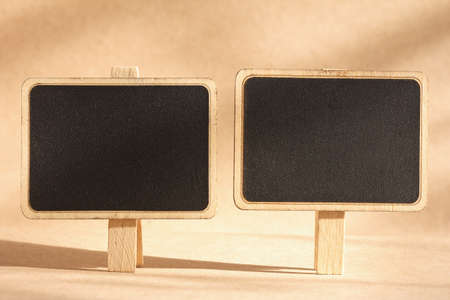 blank standing blackboard on brown backgroundの写真素材