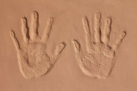 hand imprint on concrete wall