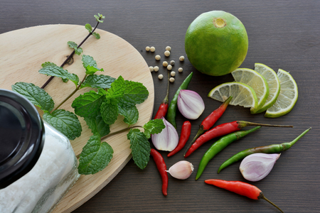 Asian cuisine ingredients food, top view spice lemon onion garlic chili pepper mint salt for cooking original eastern foods style on top wood texture background Thailand food spicesの写真素材