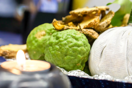 Close up herbal spa balls and bergamots with ginger slice for treatment or massage in Thai spa.の写真素材