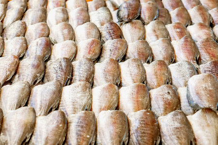 Dried gourami fish lined up for sale to customers in the market.の写真素材