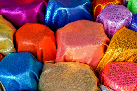 Top view and colorful of Saree fabrics fit to screen background and textured. Saree fabrics is Traditional indian women dress Used as both the garment and the blanket.の写真素材