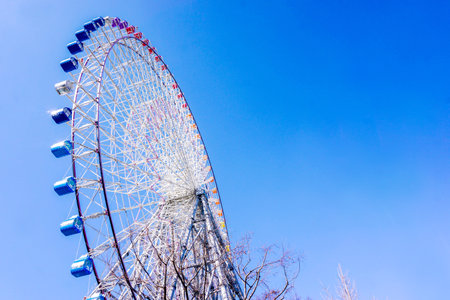 Closeup and crop Tempozan Giant Ferris Wheel on bright blue sky background with space for texts.の写真素材
