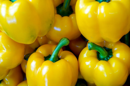 Closeup and crop heap of sweet yellow bell pepper fit on screen background and wallpaper.の写真素材