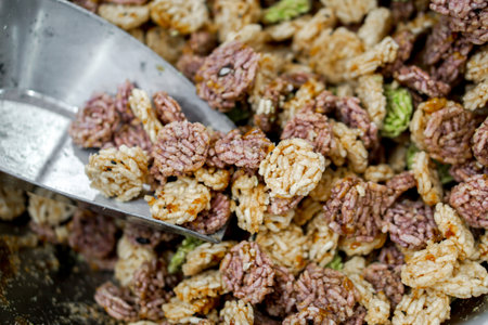Closeup and crop Thai northern rice cracker snack Khao tan with scoop. Khao tan is an important...