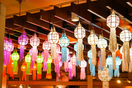 Closeup Colorful perspective view of Thai Lanna style lanterns to hanging on the ceiling and turn on light at night.の写真素材