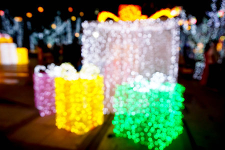 Closeup and blurred of Christmas holiday lighting in gift box shape and on night time background.