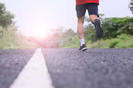 Runner athlete running on road. fitness jogging workout wellness concept.の写真素材