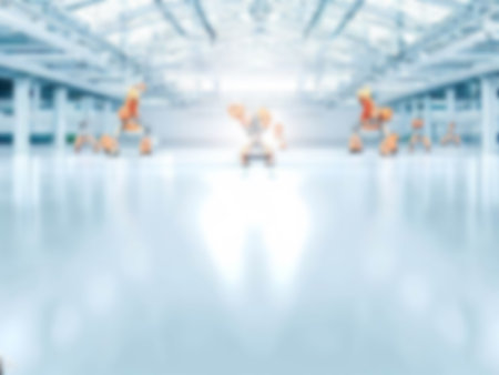 blurred A factory building operated by industrial robots and automation with a lot of usable space background. light blue colorの素材