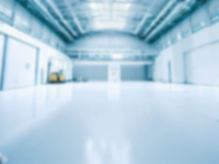 blurred An empty factory building with a lot of usable space background. light blue colorの素材