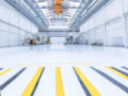 blurred An empty factory building and crane with a lot of usable space background. light blue colorの素材