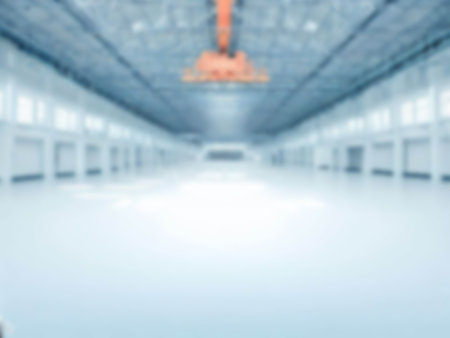 blurred An empty factory building and crane with a lot of usable space background. light blue colorの素材