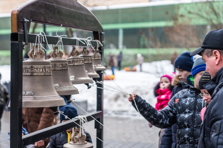 WInter 2015. Day. Russia. Moscow. Maslenitsa (pancake week). Masterclass from the team of bell ringers Crimson Bells. The Children are trying to ring the bells.のeditorial素材