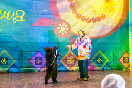 Winter 2015. Day. Russia. Moscow. Maslenitsa (pancake week). The animal trainer with the bear on stage.のeditorial素材