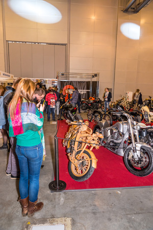 Winter 2015. Morning. Russia. Moscow. Crocus-Expo. Exhibition Motopark-2015 (BikePark-2015). Custom Zone. Visitors are watching on the unique motorcycles.のeditorial素材