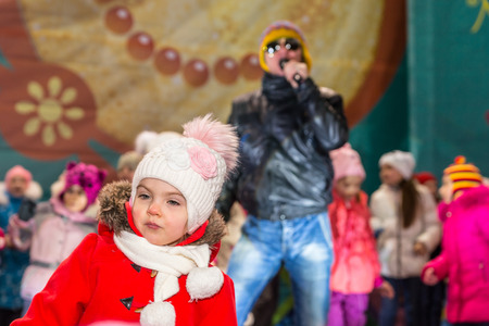 Winter 2015. Day. Russia. Moscow. Maslenitsa (pancake week). The Celebration of Maslenitsa (pancake week). The concert in honor of the Holiday. The performance of Michael Grebenshchikov. Children dancing on scene with Michael Grebenshikov.のeditorial素材