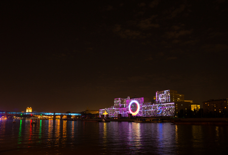 Russia. Moscow - September 26, 2015. The opening of the Festival Circle Of Light. Gorkiy Park. The complex of buildings of the Ministry of Defense and the Andreevskiy Bridge during the Show.のeditorial素材