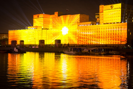 Russia. Moscow - September 26, 2015. The opening of the Festival Circle Of Light. Gorkiy Park. The complex of buildings of the Ministry of Defense and the Andreevskiy Bridge during the Show.のeditorial素材
