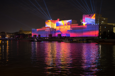 Russia. Moscow - September 26, 2015. The opening of the Festival Circle Of Light. Gorkiy Park. The complex of buildings of the Ministry of Defense and the Andreevskiy Bridge during the Show.のeditorial素材