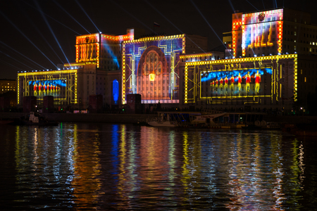 Russia. Moscow - September 26, 2015. The opening of the Festival Circle Of Light. Gorkiy Park. The complex of buildings of the Ministry of Defense and the Andreevskiy Bridge during the Show.のeditorial素材