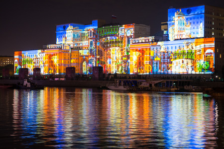 Russia. Moscow - September 26, 2015. The opening of the Festival Circle Of Light. Gorkiy Park. The complex of buildings of the Ministry of Defense and the Andreevskiy Bridge during the Show.のeditorial素材