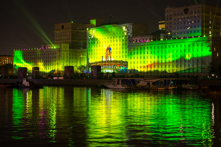 Russia. Moscow - September 26, 2015. The opening of the Festival Circle Of Light. Gorkiy Park. The complex of buildings of the Ministry of Defense and the Andreevskiy Bridge during the Show.のeditorial素材