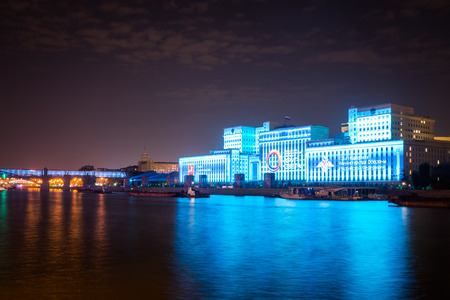 Russia. Moscow - September 26, 2015. The opening of the festival Circle Of Light 2015. Gorky Park. View of the complex of buildings of the Ministry of Defense and Andreevskiy Bridge during the show.のeditorial素材