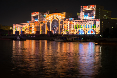 Russia. Moscow - September 26, 2015. The opening of the Festival Circle Of Light. Gorkiy Park. The complex of buildings of the Ministry of Defense and the Andreevskiy Bridge during the Show.のeditorial素材