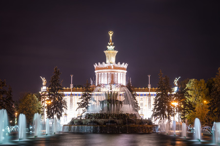 Russia. Moscow - September 27, 2015. ENEA VDNH. The Stone Flower Fountain in the background of the pavilion of Agriculture Ukrainian SSR.のeditorial素材
