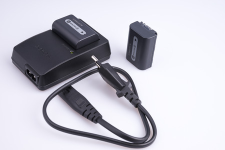 Russia. Moscow - April 26, 2015. Sony battery charger with batteries and power cable.