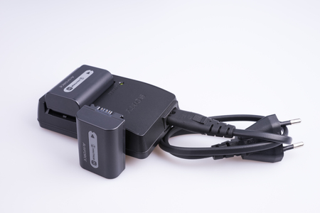 Russia. Moscow - April 26, 2015. Sony battery charger with batteries and power cable.