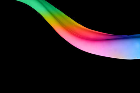 Colored paint splashes isolated on black backgroundの写真素材