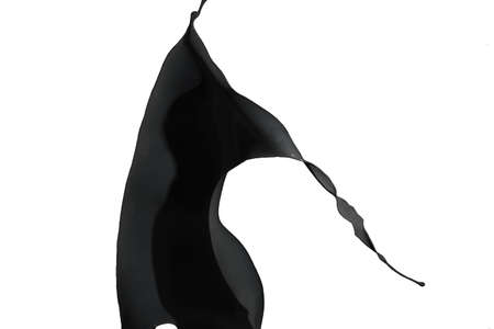 Black paint splash isolated on white background.の写真素材