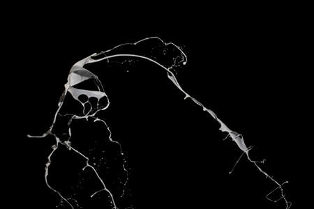 White paint splash isolated on black background.の写真素材