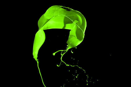 Green paint splash isolated on black  background.の写真素材