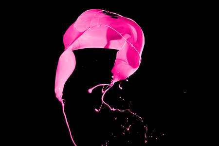 Pink paint splash isolated on black background.の写真素材