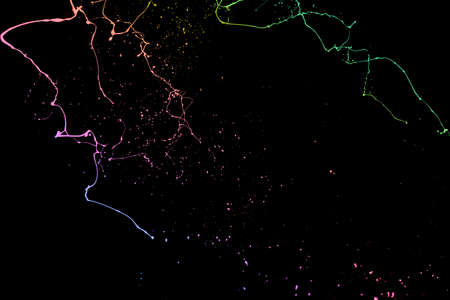Colored paint splashes isolated on black background