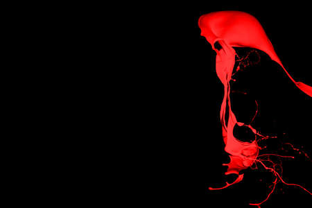Red paint splash isolated on black background.