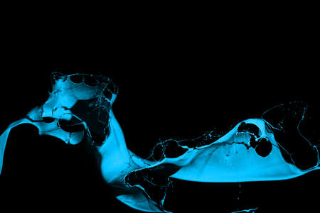 Blue paint splash isolated on black background.の写真素材