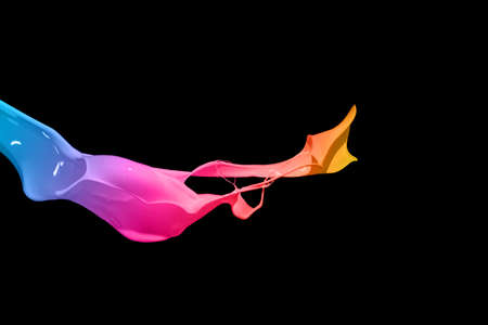 Colorful paint splashing isolated on blackの写真素材