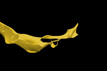 Yellow paint splash isolated on black background.の写真素材