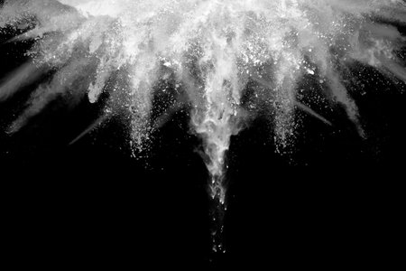 White powder explosion on black background. Colored cloud. Colorful dust explode. Paint Holi.