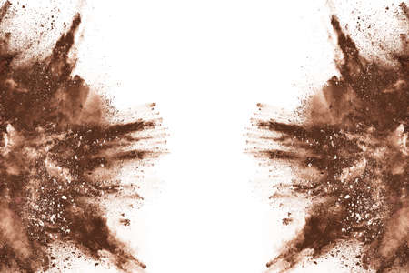 Brown color powder explosion on white background. Colored cloud. Colorful dust explode. Paint Holi.の写真素材