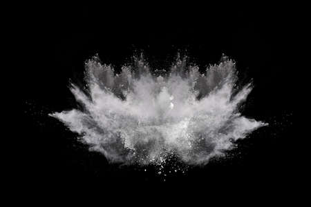 White powder explosion on black background. Colored cloud. Colorful dust explode. Paint Holi.